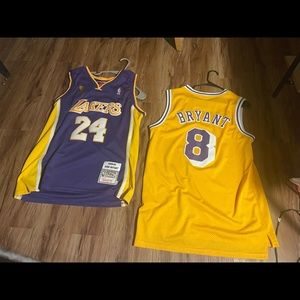Two Kobe Bryant hardwood classic jerseys and one is a finals jersey